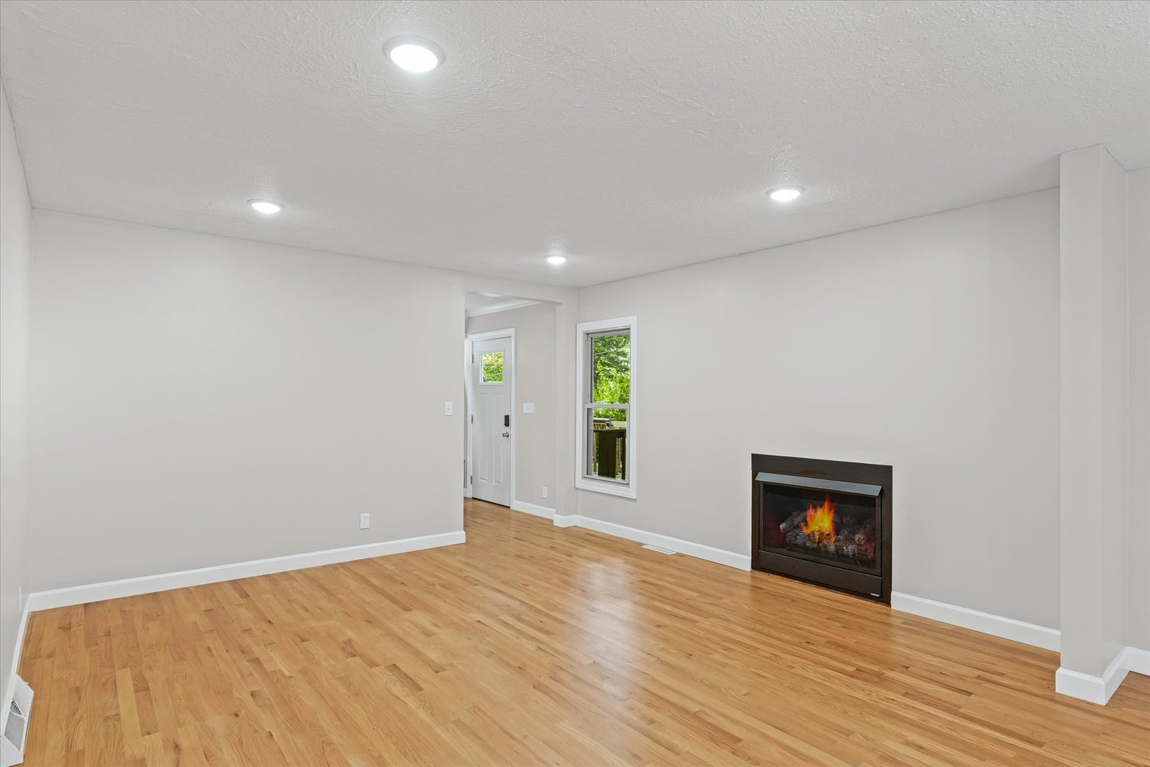 1101 East Pin Oak Drive Mahomet, IL 61853 - Photo 12 of 57 a view of an empty room with wooden floor and a window