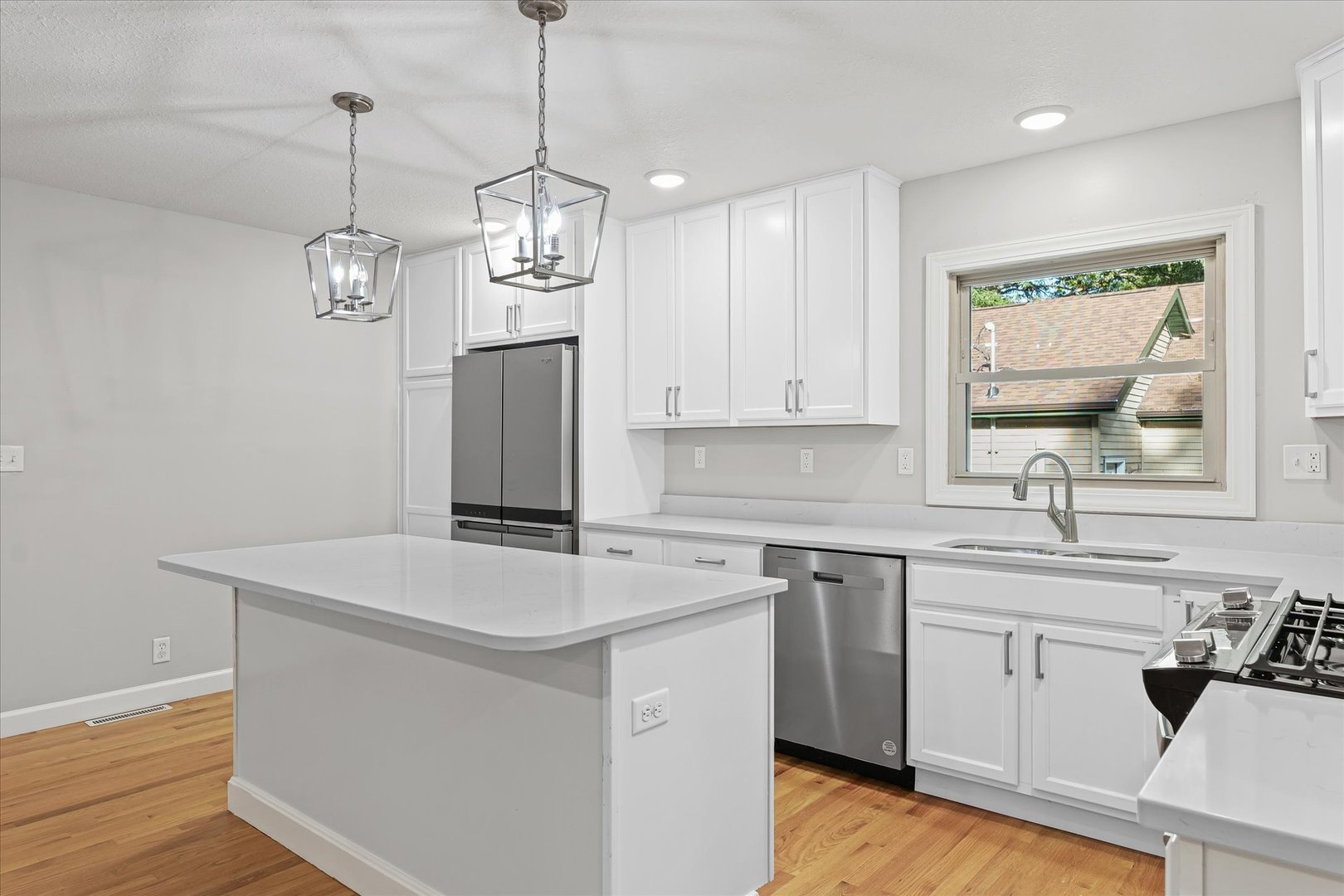 1101 East Pin Oak Drive Mahomet, IL 61853 - Photo 16 of 57 a kitchen that has a sink a window and stainless steel appliances