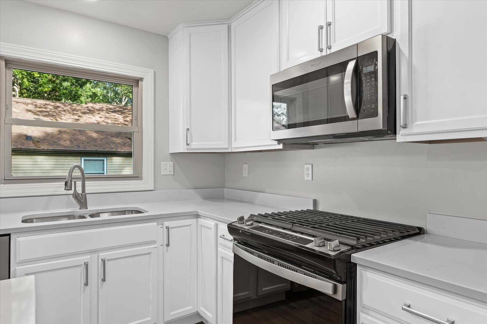1101 East Pin Oak Drive Mahomet, IL 61853 - Photo 18 of 57 a kitchen with granite countertop white cabinets stainless steel appliances and a sink