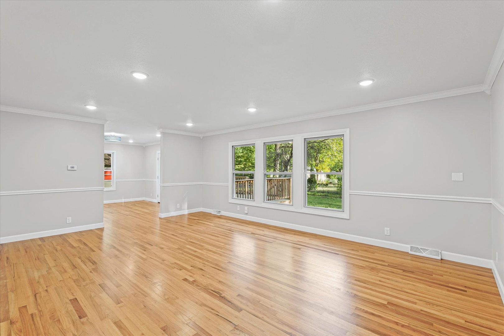 1101 East Pin Oak Drive Mahomet, IL 61853 - Photo 25 of 57 a view of an empty room with wooden floor and a window