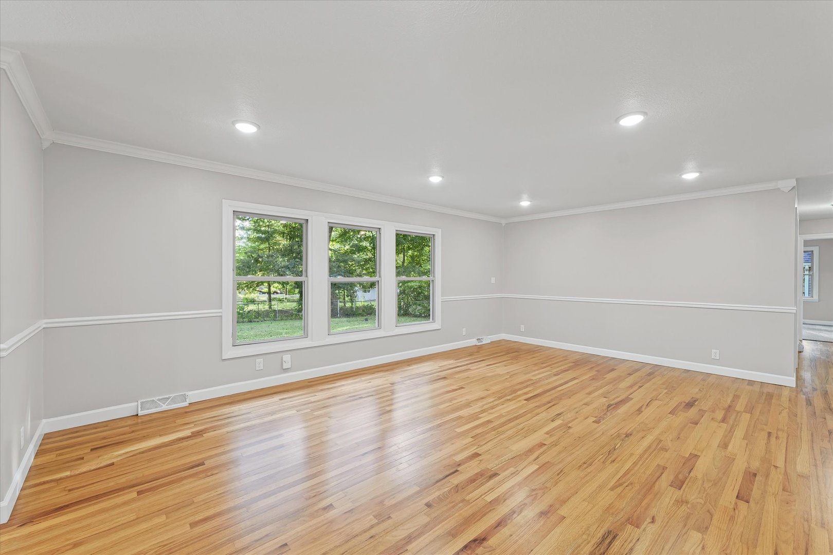 1101 East Pin Oak Drive Mahomet, IL 61853 - Photo 26 of 57 a view of an empty room with wooden floor and a window