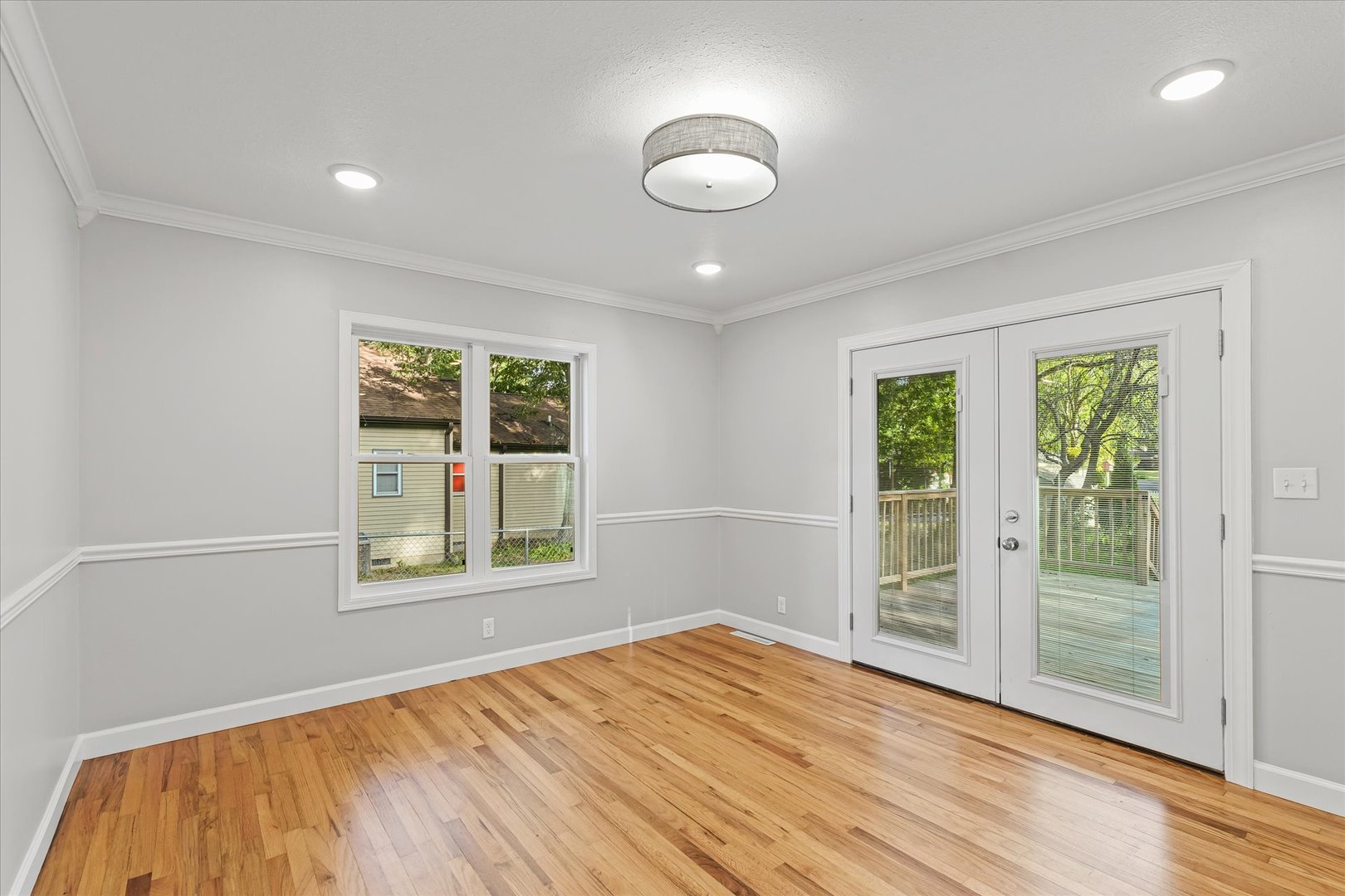 1101 East Pin Oak Drive Mahomet, IL 61853 - Photo 27 of 57 a view of an empty room with wooden floor and a window