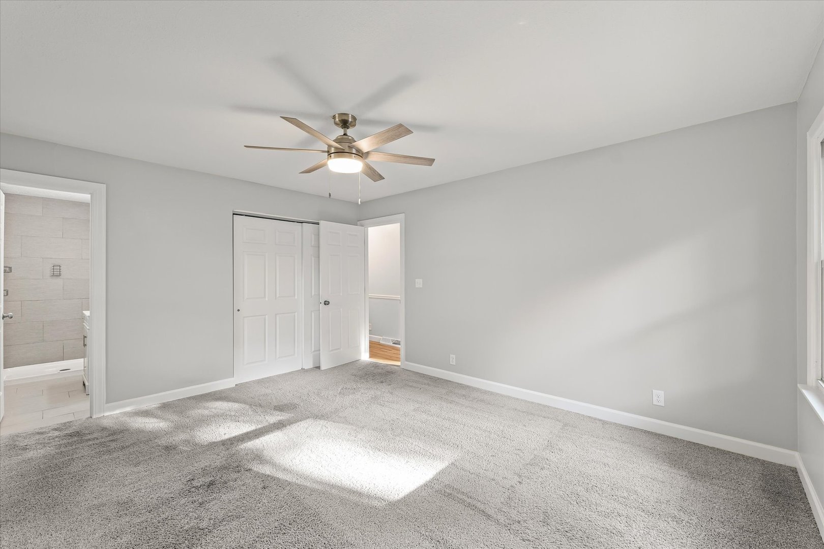 1101 East Pin Oak Drive Mahomet, IL 61853 - Photo 35 of 57 an empty room with chandelier fan and windows