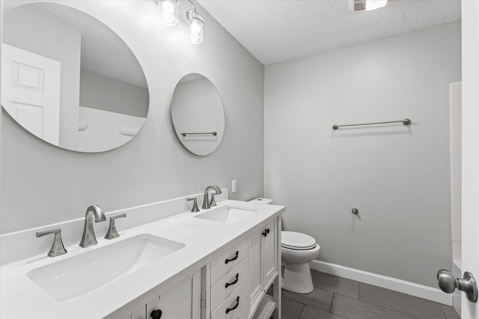 1101 East Pin Oak Drive Mahomet, IL 61853 - Photo 38 of 57 a bathroom with a toilet a sink and mirror