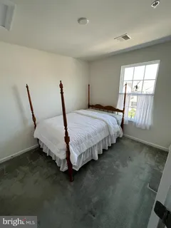 a bed sitting in a room next to a window