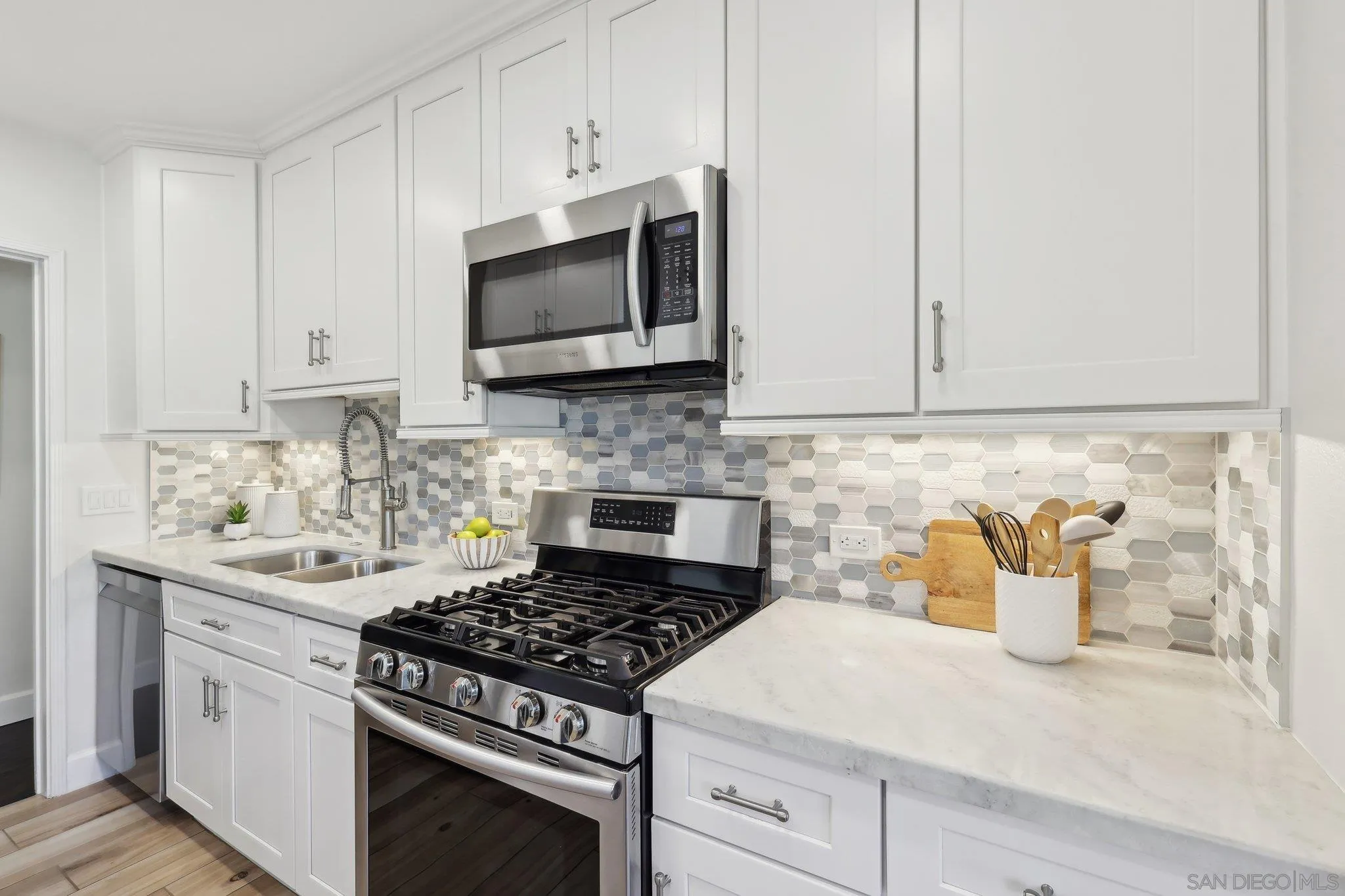 506 South Freeman Street Oceanside, CA 92054 - Photo 6 of 20 a kitchen with stainless steel appliances white cabinets and stove