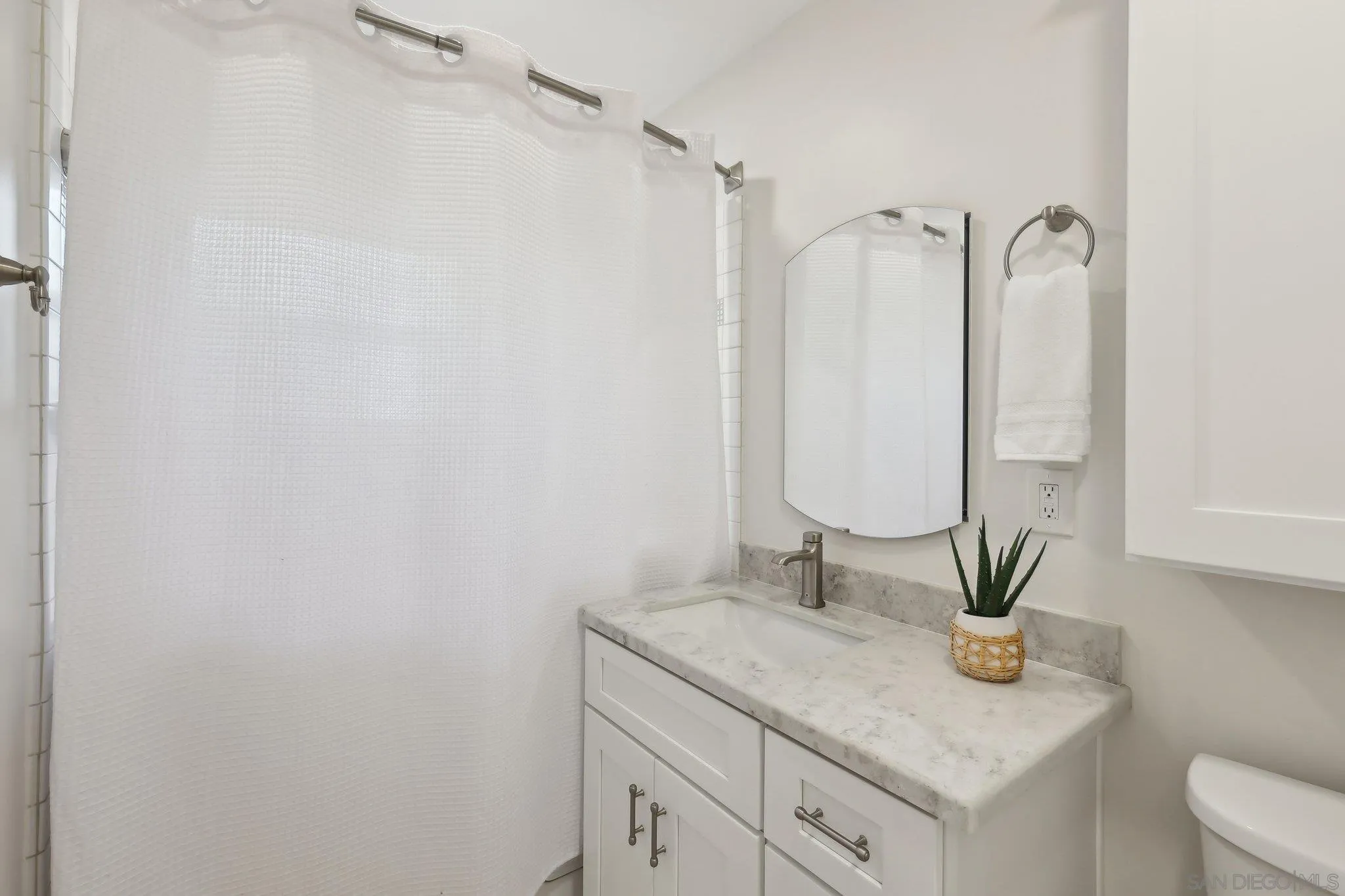 506 South Freeman Street Oceanside, CA 92054 - Photo 9 of 20 a bathroom with a granite countertop sink a toilet and with mirror