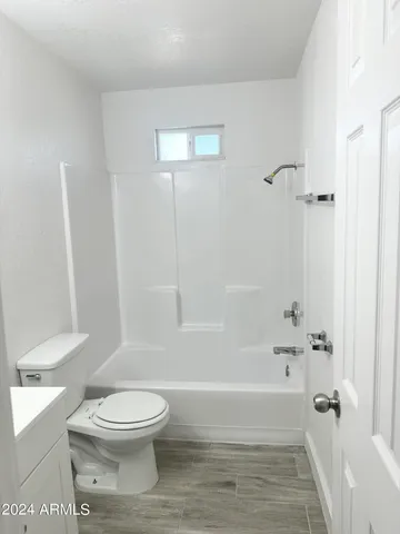 a bathroom with a toilet and a bath tub
