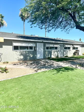 a front view of a house with a garden and yard