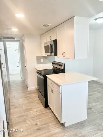 a view of a kitchen with electric appliances