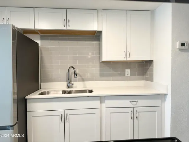 a kitchen with a sink and cabinets