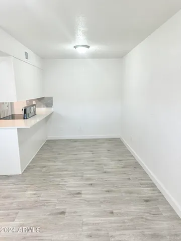 a view of a kitchen with wooden floor