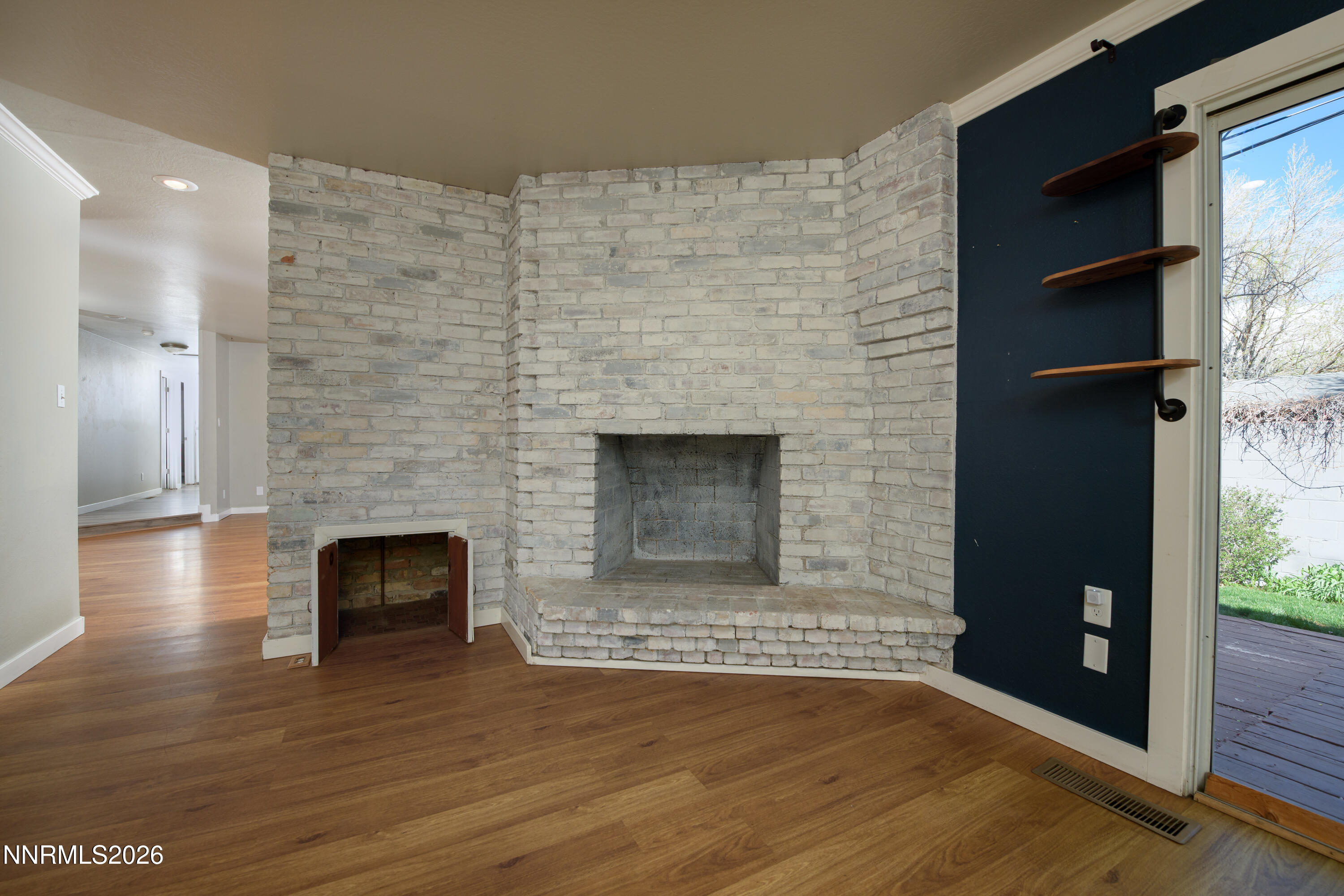 901 Sharrow Way Carson City, NV 89703 - Photo 16 of 45 a view of an empty room with wooden floor and a fireplace