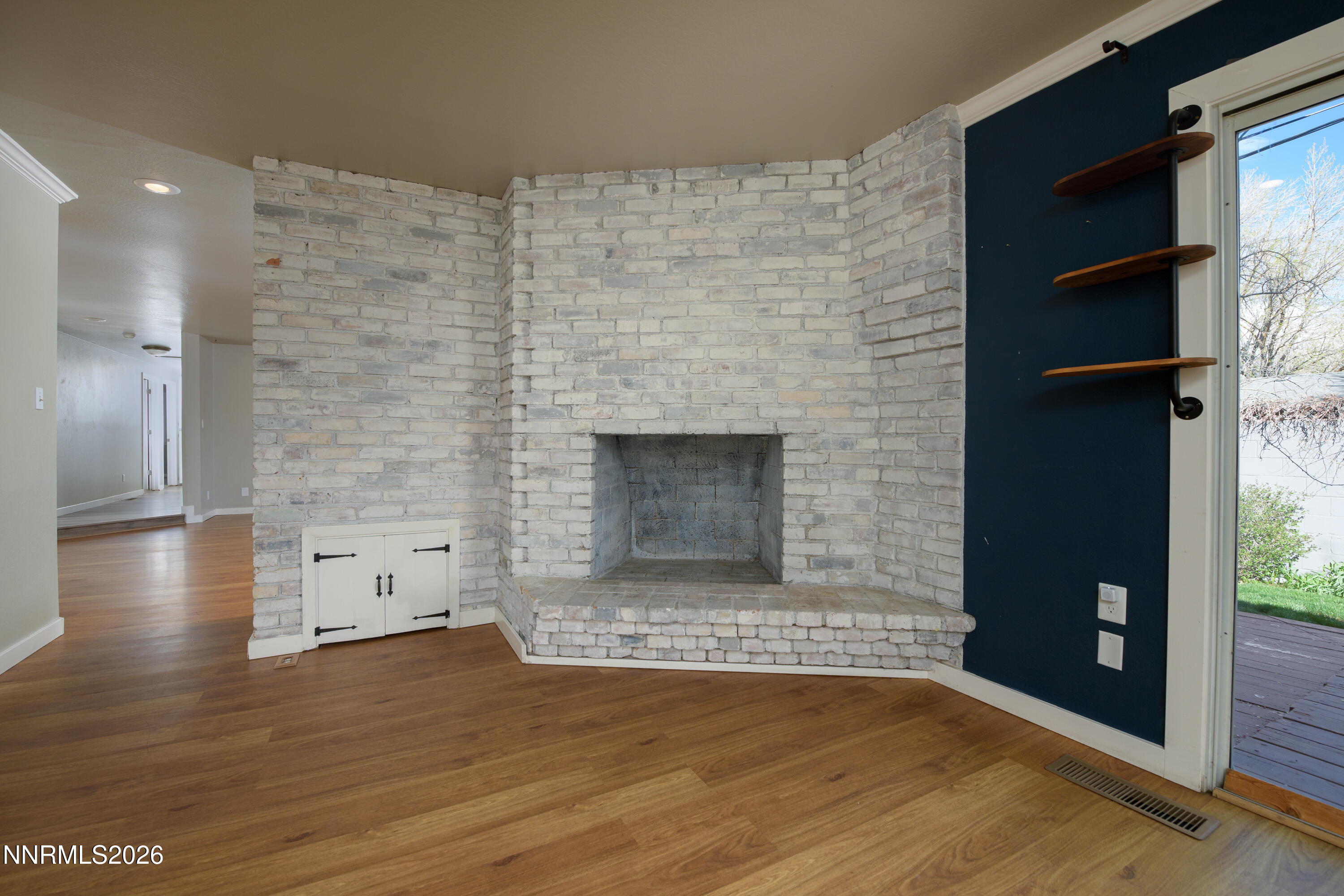 901 Sharrow Way Carson City, NV 89703 - Photo 17 of 45 a view of empty room with wooden floor and fireplace