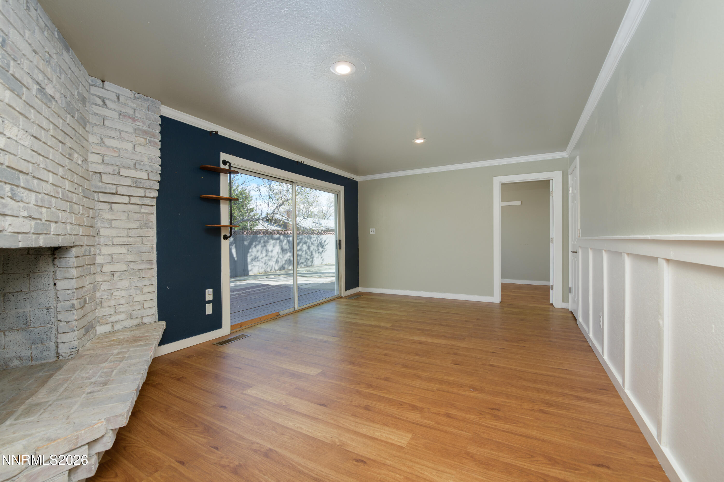 901 Sharrow Way Carson City, NV 89703 - Photo 18 of 45 a view of an empty room with wooden floor and a window