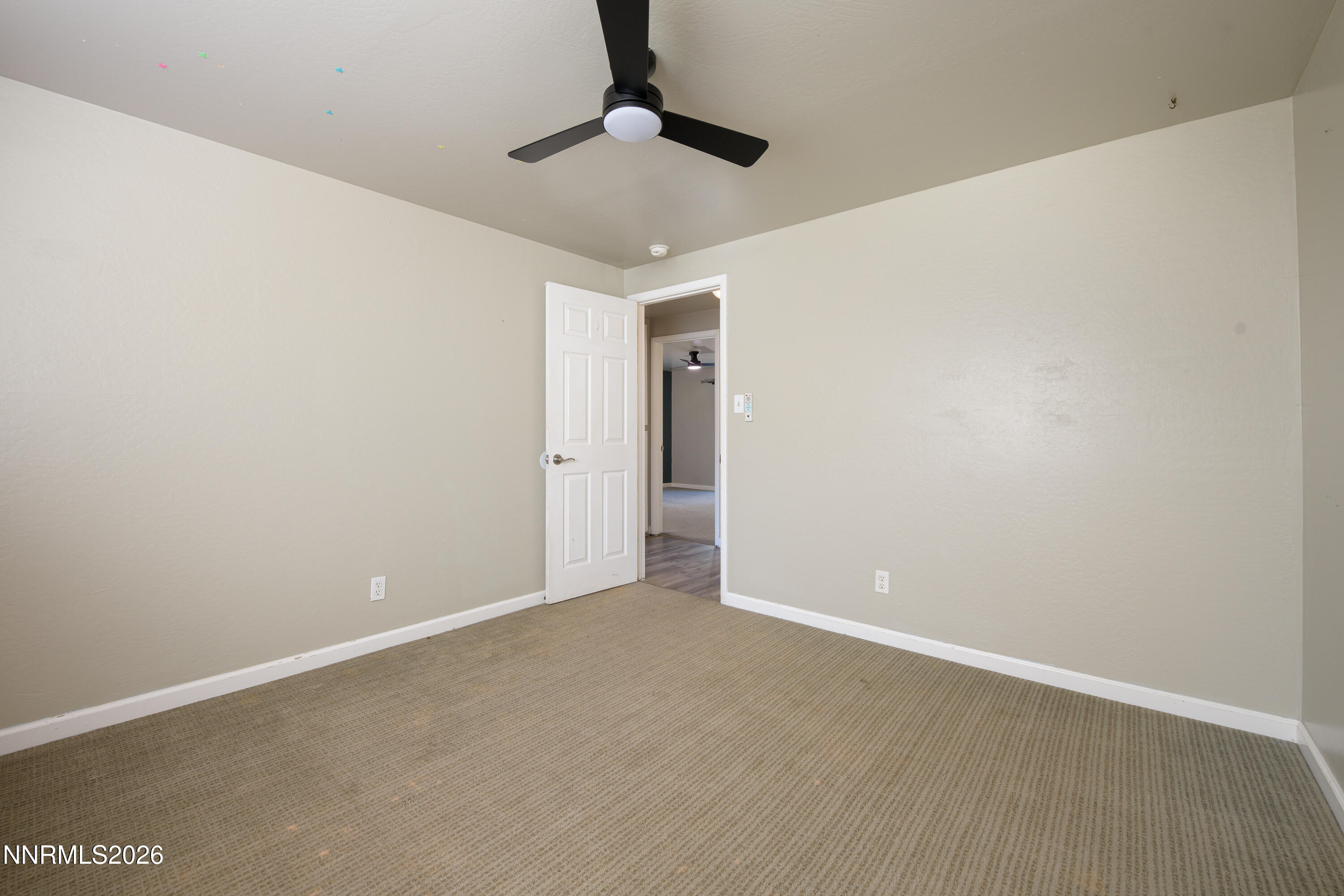 901 Sharrow Way Carson City, NV 89703 - Photo 21 of 45 an empty room with a ceiling fan and carpet