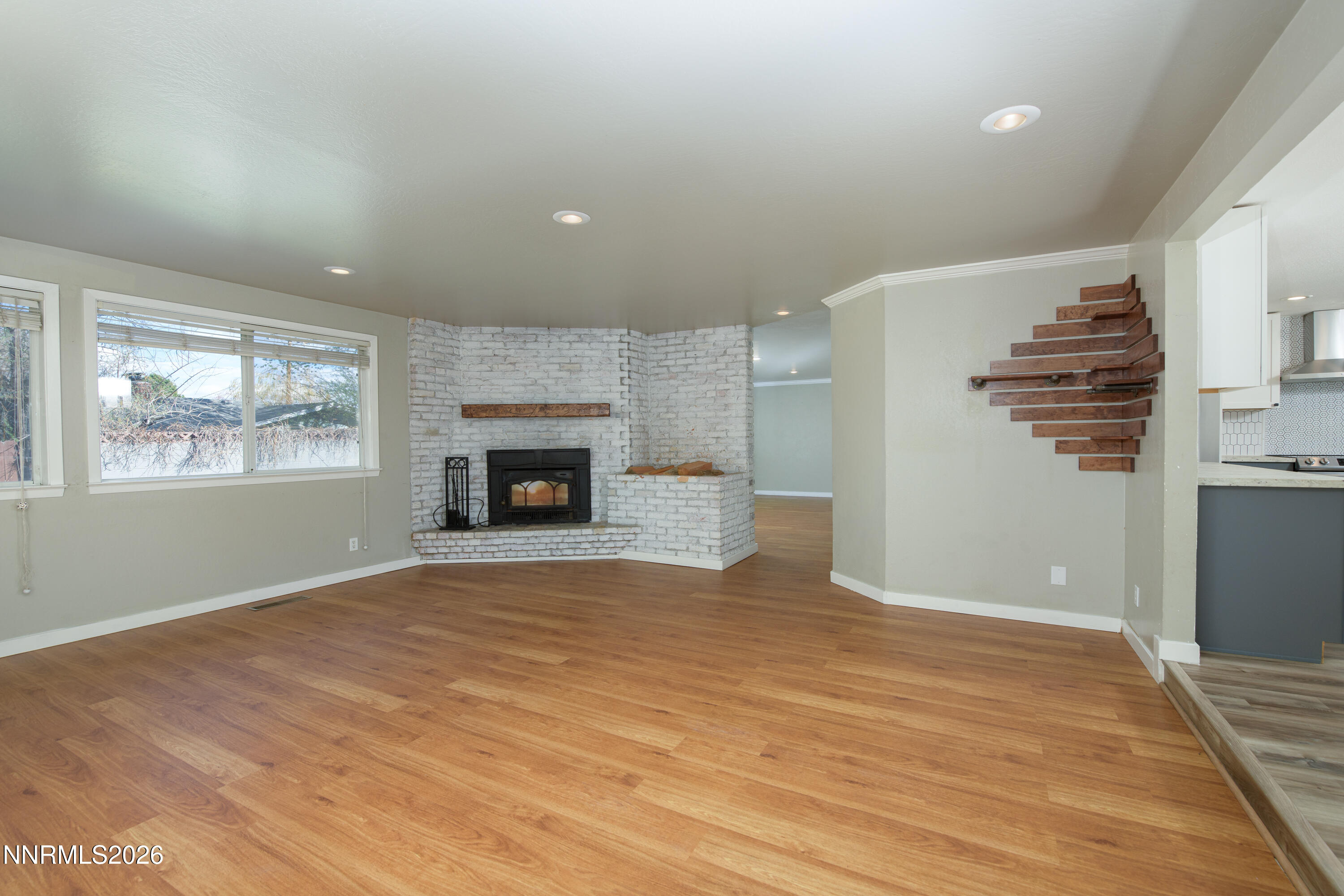 901 Sharrow Way Carson City, NV 89703 - Photo 5 of 45 a view of empty room with wooden floor and fireplace