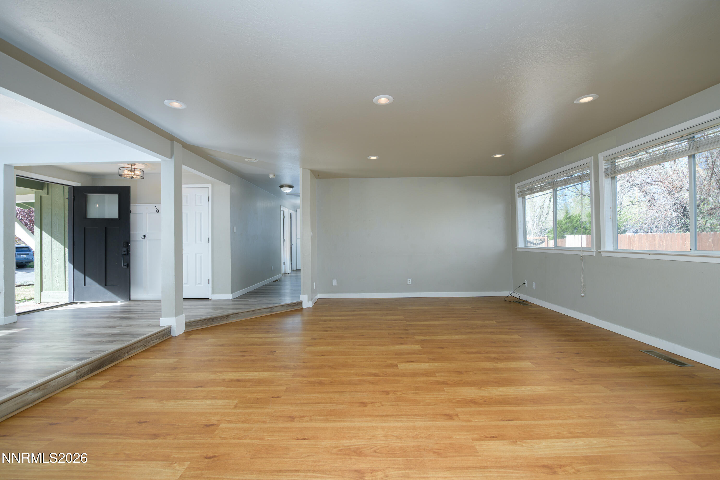 901 Sharrow Way Carson City, NV 89703 - Photo 6 of 45 a view of an empty room with wooden floor and a window