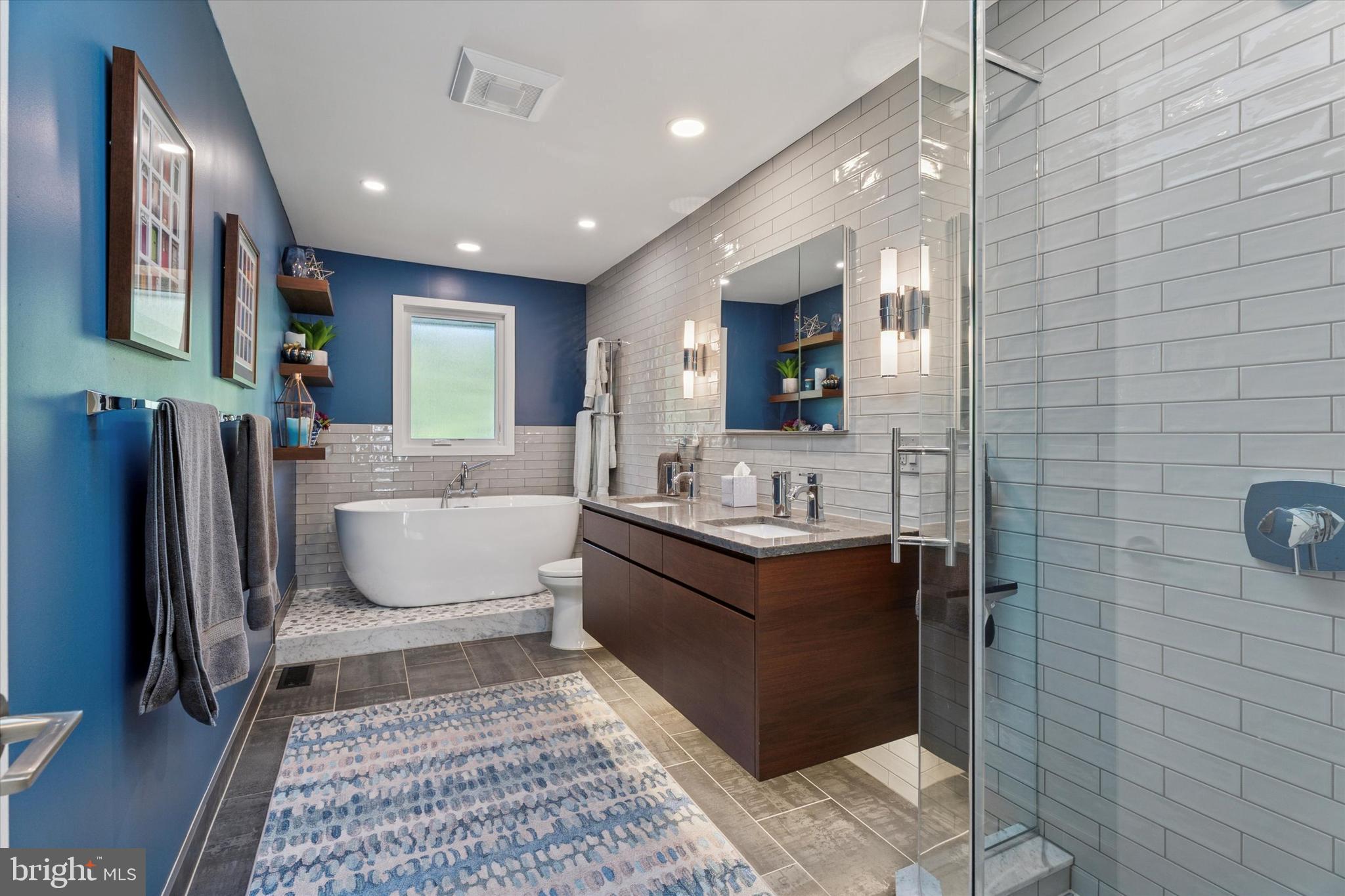 1641 Chattin Road Glenside, PA 19038 - Photo 23 of 48 a large bathroom with a large mirror vanity and toilet