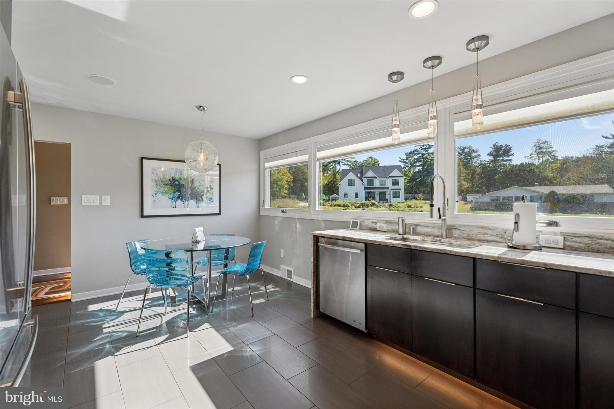 1641 Chattin Road Glenside, PA 19038 - Photo 10 of 48 a kitchen with granite countertop a stove a sink a dining table and chairs