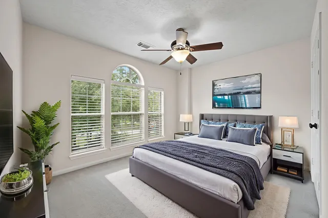 a bedroom with a large bed and a large window