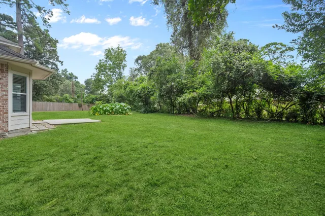 a view of a field of grass and trees