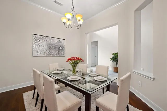 a view of a dining room with furniture and chandelier