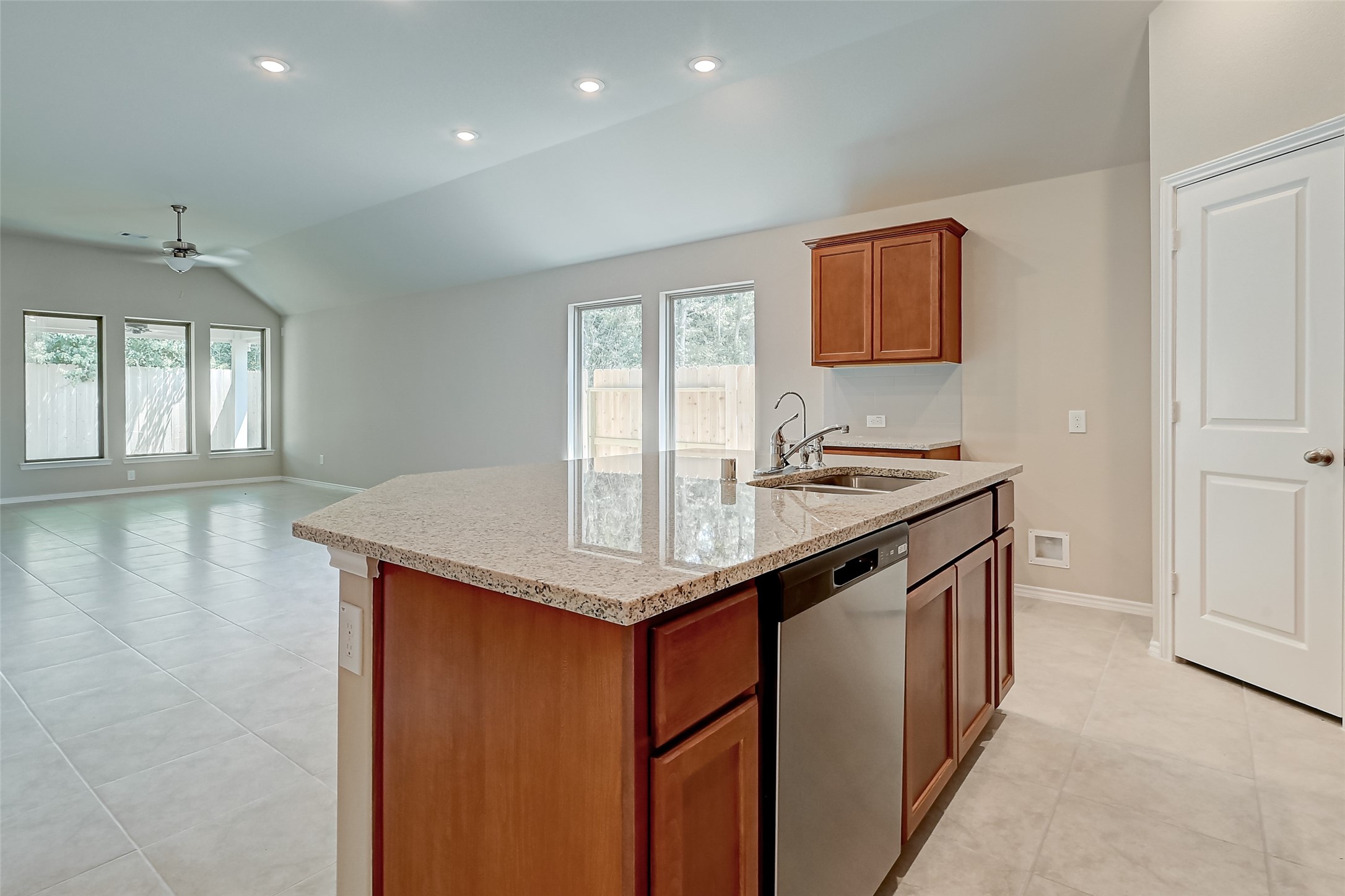 32037 Towering Birch Trail Conroe, TX 77385 - Photo 11 of 38 a kitchen with stainless steel appliances granite countertop a sink a stove and a refrigerator