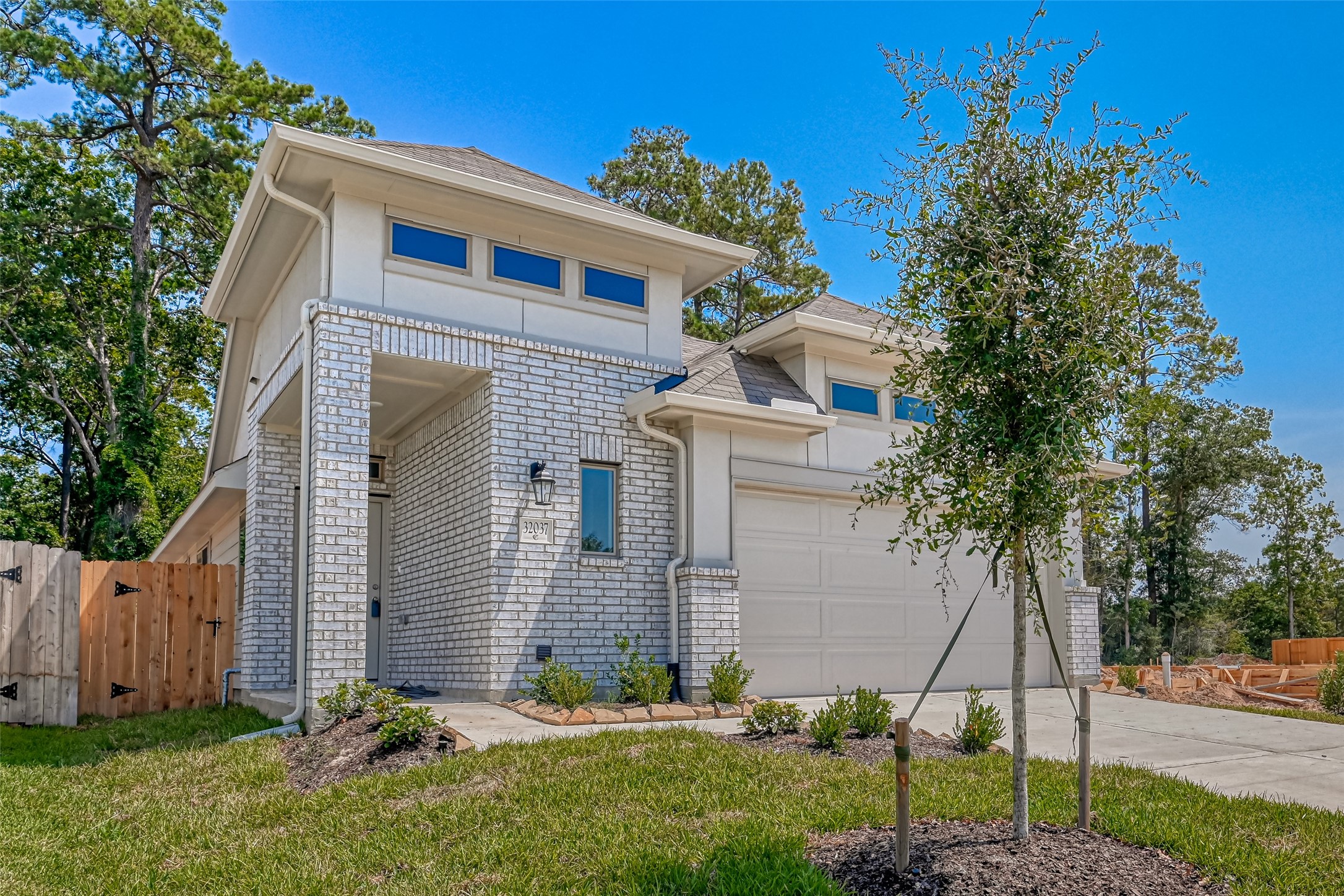 32037 Towering Birch Trail Conroe, TX 77385 - Photo 2 of 38 a front view of a house with a garden