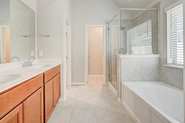 a bathroom with bathtub and window