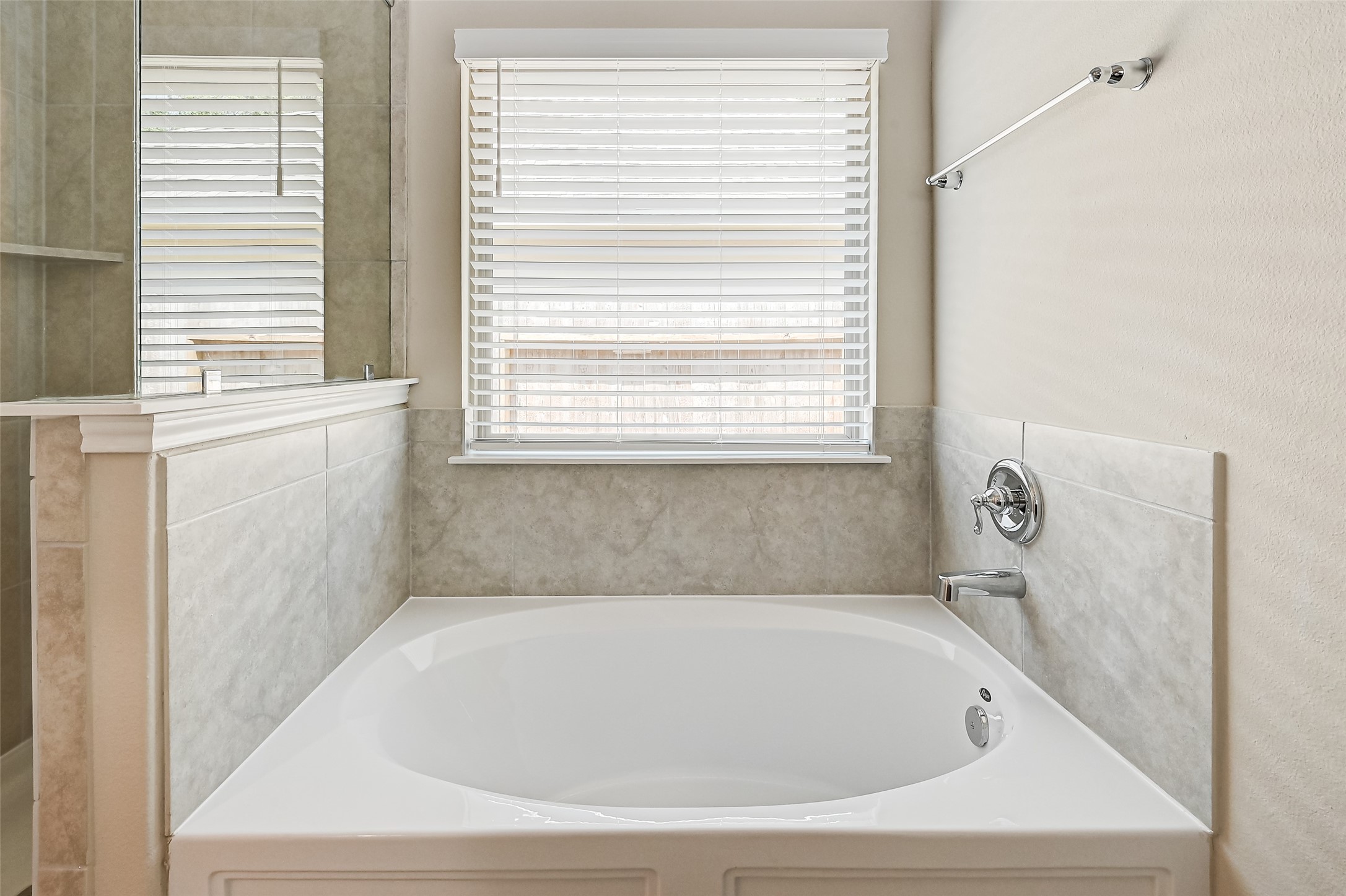 32037 Towering Birch Trail Conroe, TX 77385 - Photo 27 of 38 a bathroom with bathtub and window