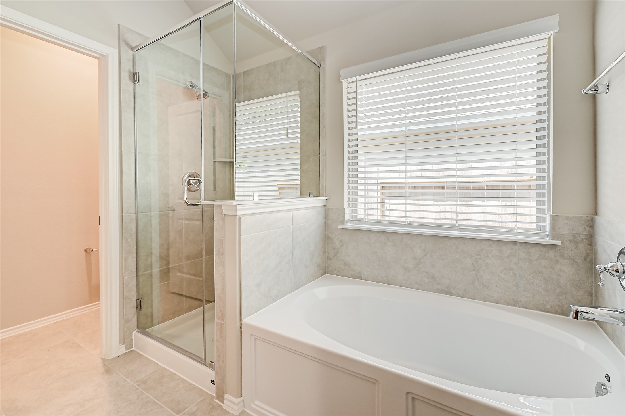 32037 Towering Birch Trail Conroe, TX 77385 - Photo 28 of 38 a bathroom with a bathtub and a shower