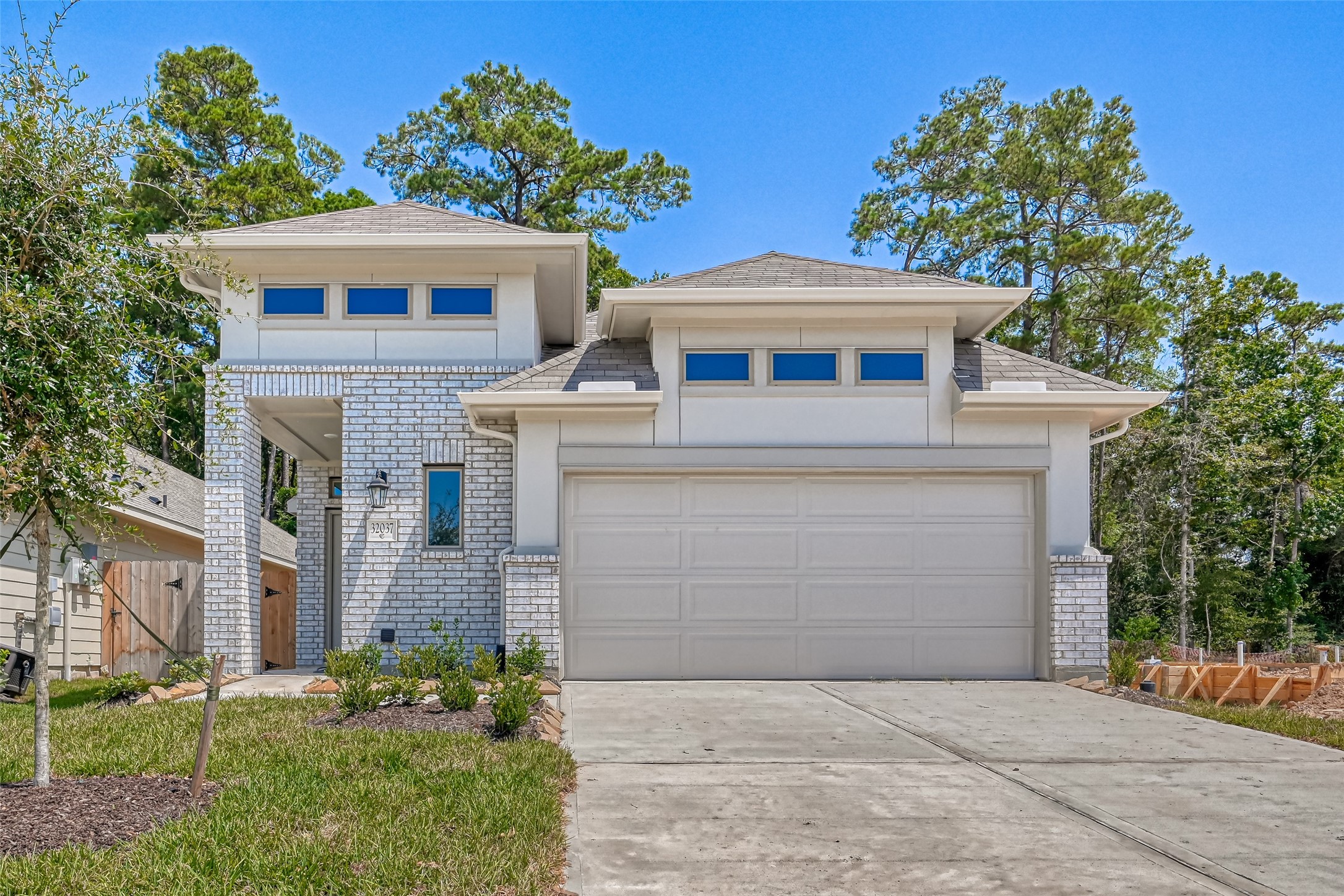 32037 Towering Birch Trail Conroe, TX 77385 - Photo 3 of 38 front view of a house with a yard