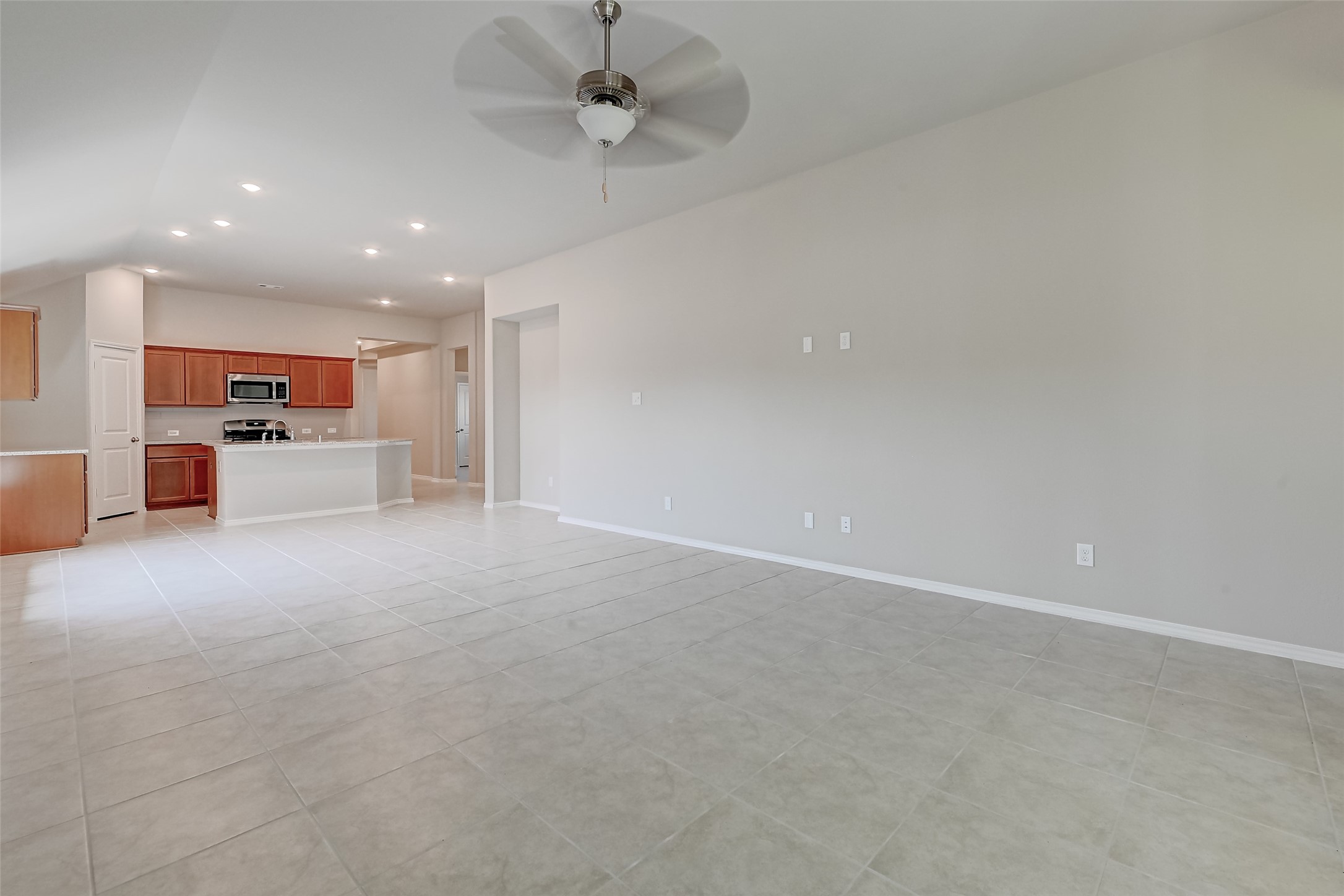 32037 Towering Birch Trail Conroe, TX 77385 - Photo 8 of 38 an empty room with furniture and a ceiling fan