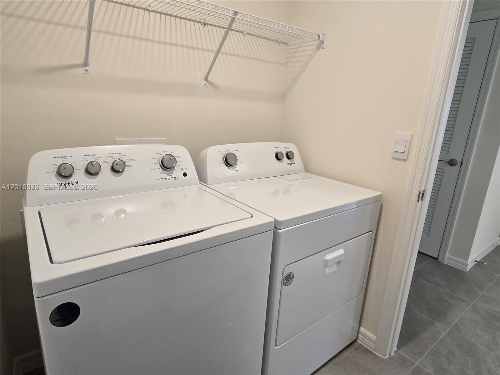 9871 Southeast 161st Lane Road Summerfield, FL 34491 - Photo 9 of 31 a utility room with dryer and washer