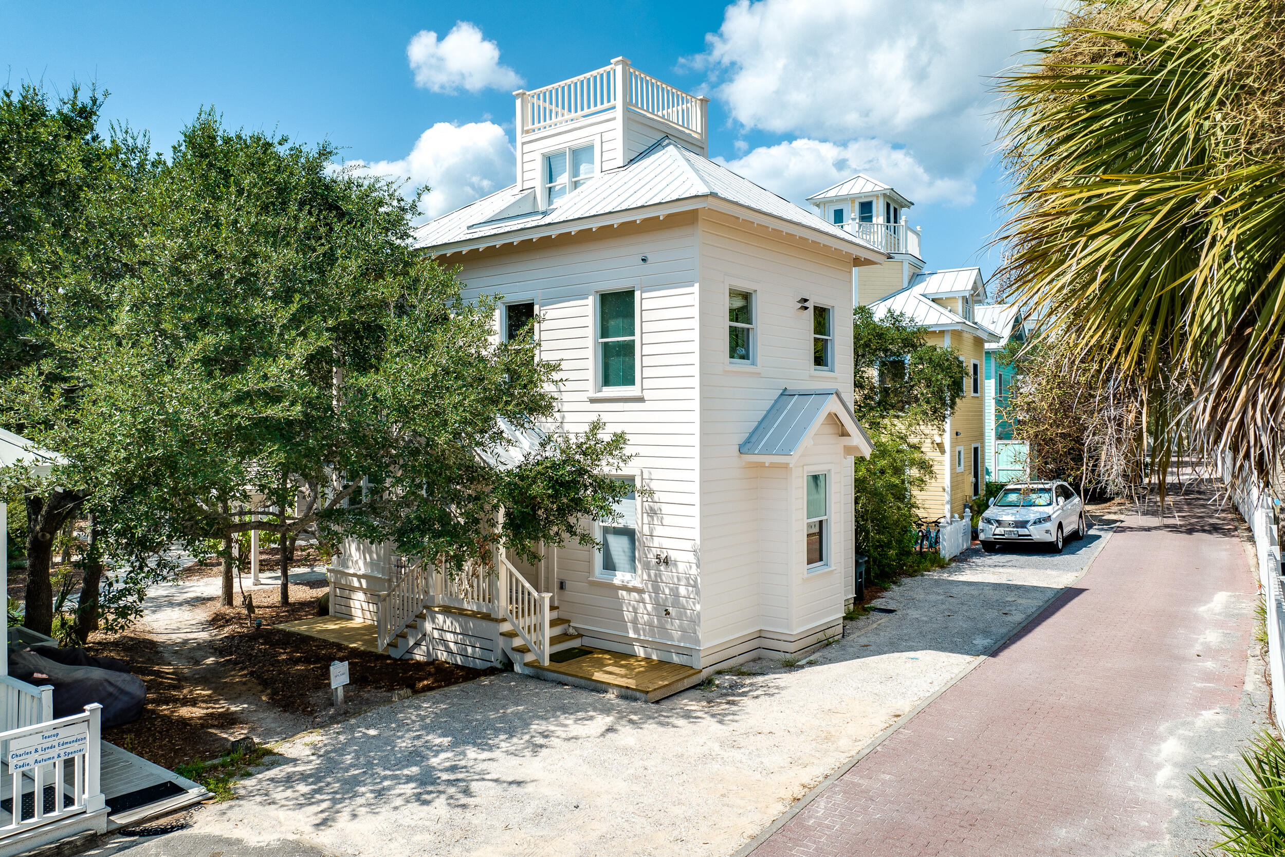 54 Roberts Way Santa Rosa Beach, FL 32459 - Photo 11 of 37 a view of a white house next to a yard with plants and trees