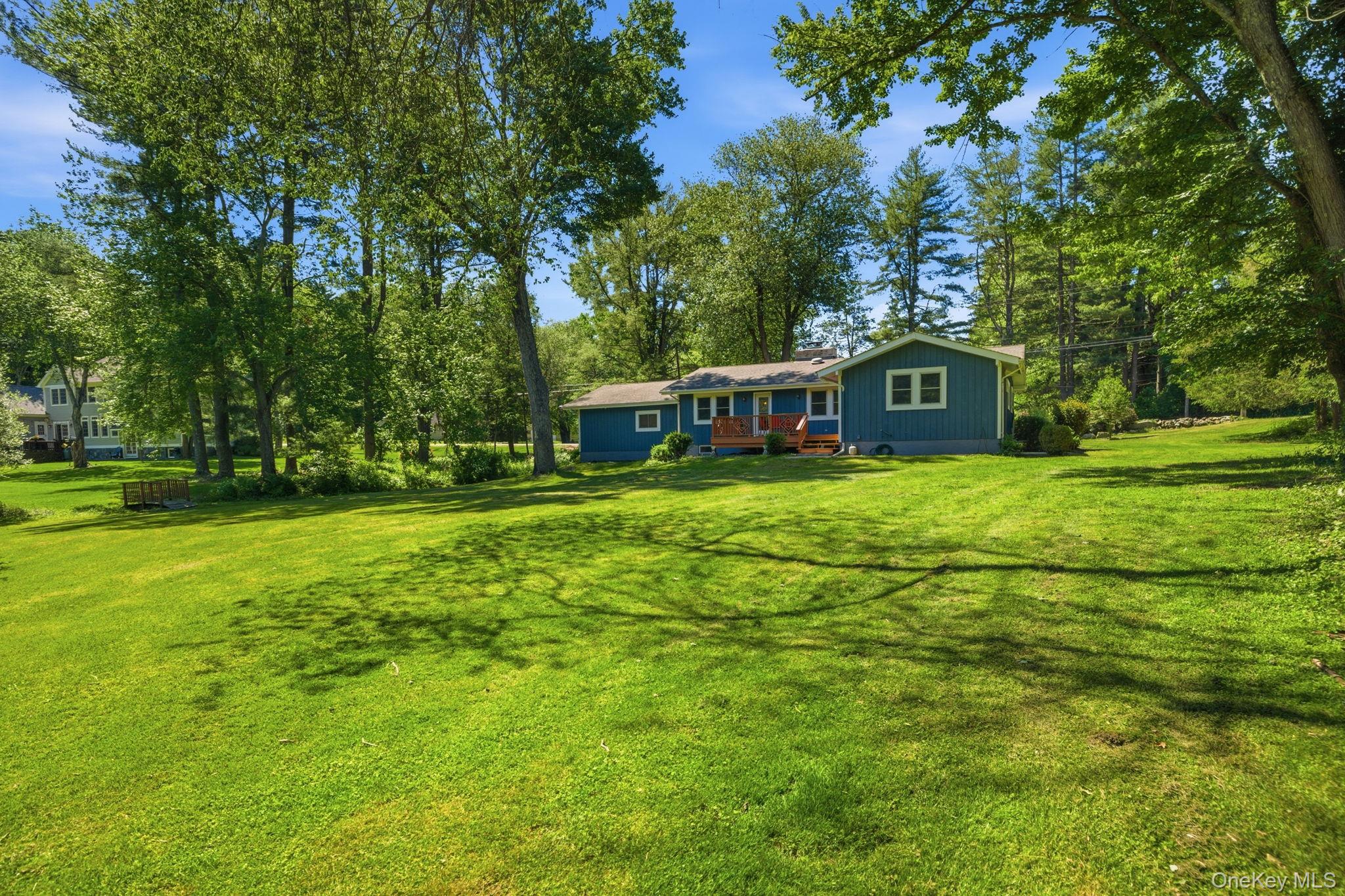 35 Deans Bridge Road Somers, NY 10589 - Photo 29 of 49 Set well back on a private 1.2-acre corner and framed by mature trees, the home looks out over an expanse of level, open lawn with room to grow into for years to come.