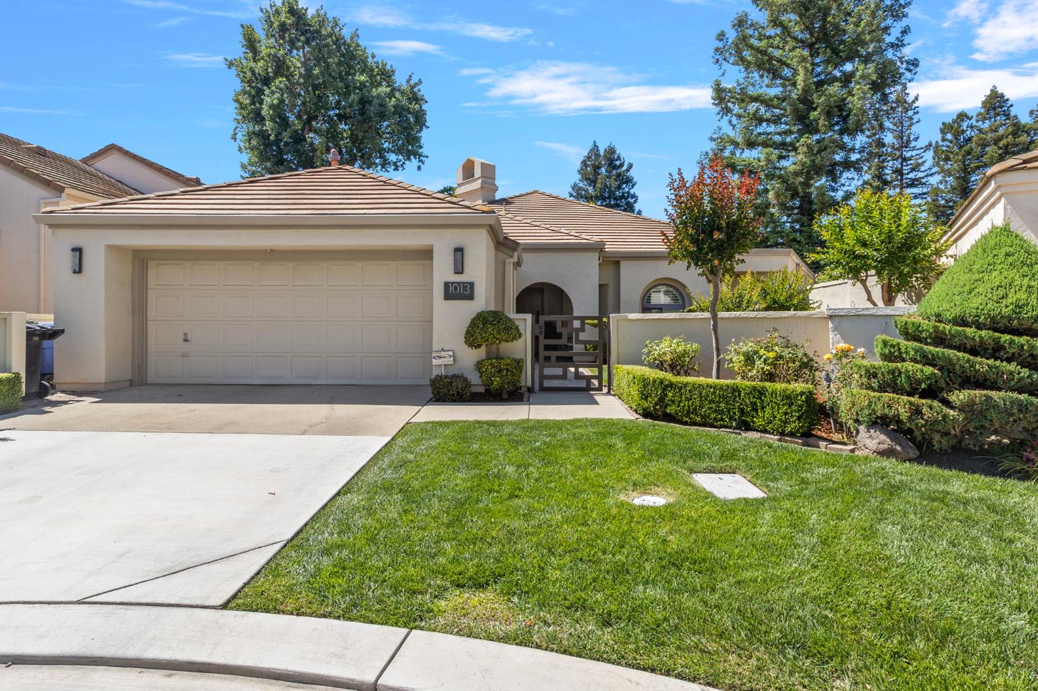 1013 Copper Lake Court Modesto, CA 95355 - Photo 2 of 66 a front view of a house with a yard and garage