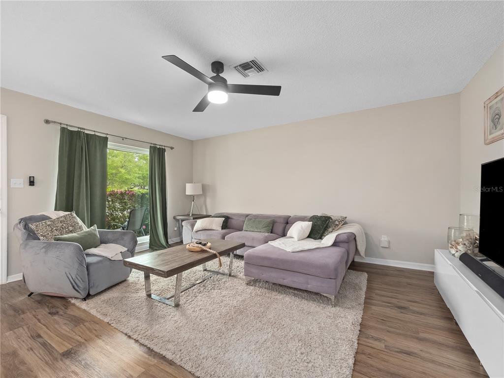 2733 Middle Street Orlando, FL 32807 - Photo 5 of 23 a living room with furniture and a flat screen tv