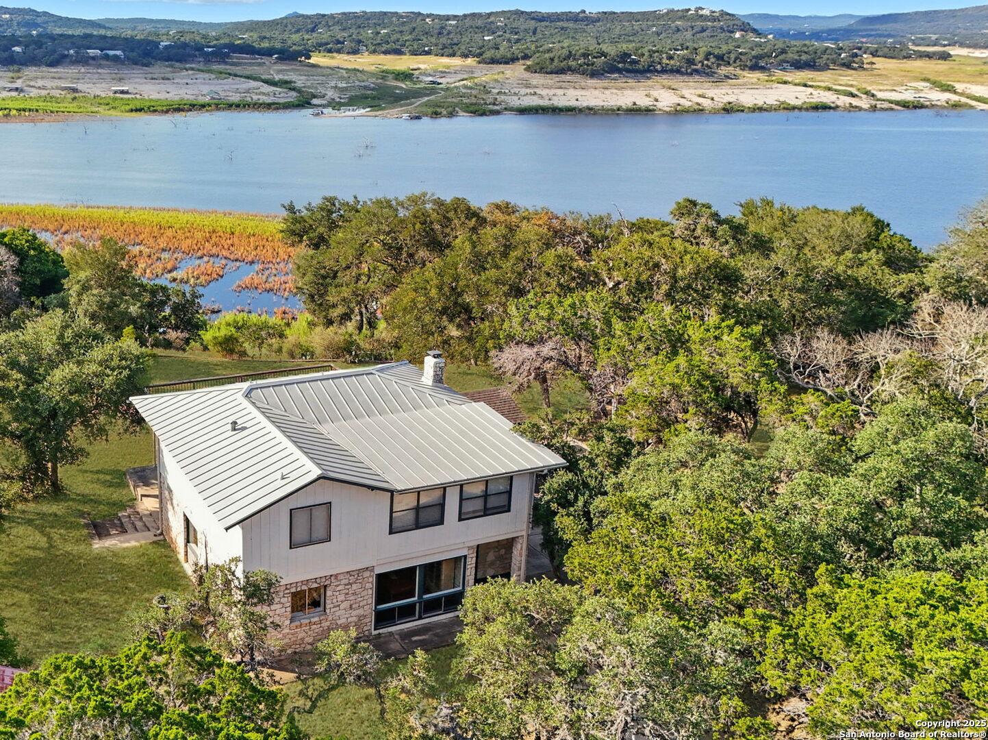 550 County Road 262 Mico, TX 78056 - Photo 1 of 58 an aerial view of a house with a lake view