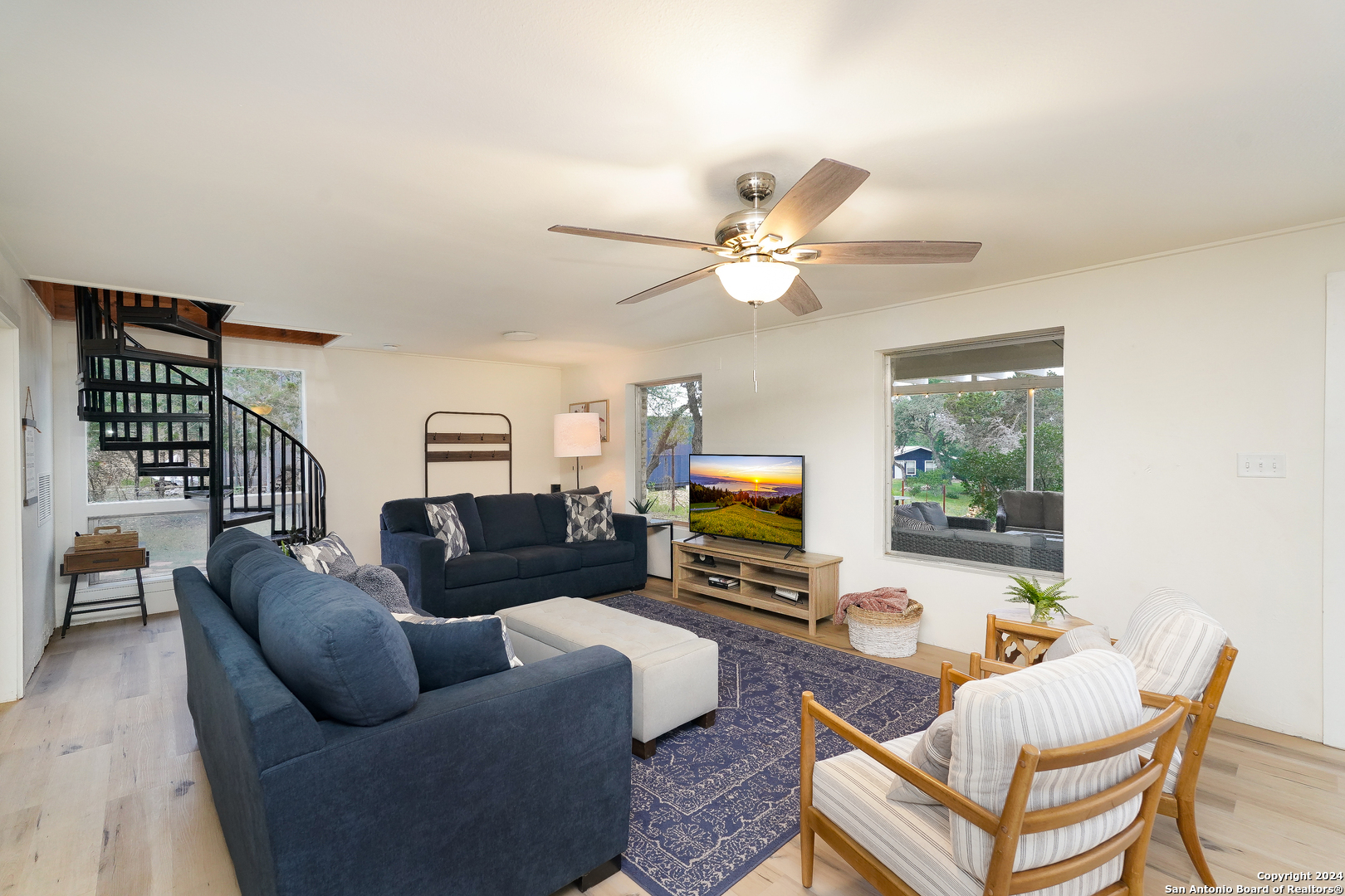 550 County Road 262 Mico, TX 78056 - Photo 11 of 58 a living room with furniture a fireplace and a flat screen tv