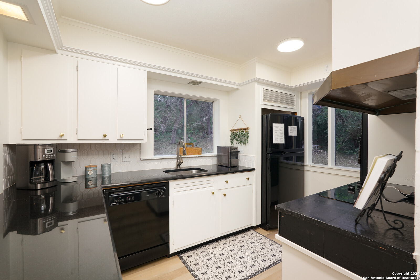 550 County Road 262 Mico, TX 78056 - Photo 16 of 58 a kitchen with stainless steel appliances granite countertop a sink and cabinets