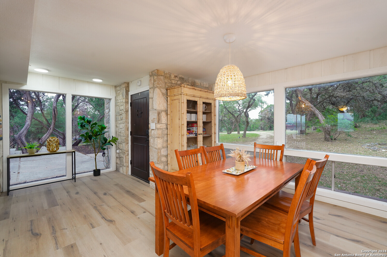 550 County Road 262 Mico, TX 78056 - Photo 18 of 58 a dining room with furniture large windows and wooden floor