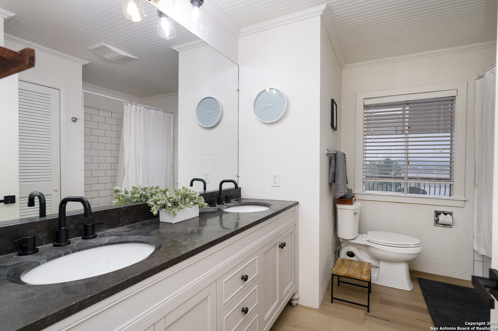 550 County Road 262 Mico, TX 78056 - Photo 27 of 58 a bathroom with a granite countertop sink a toilet a mirror and shower