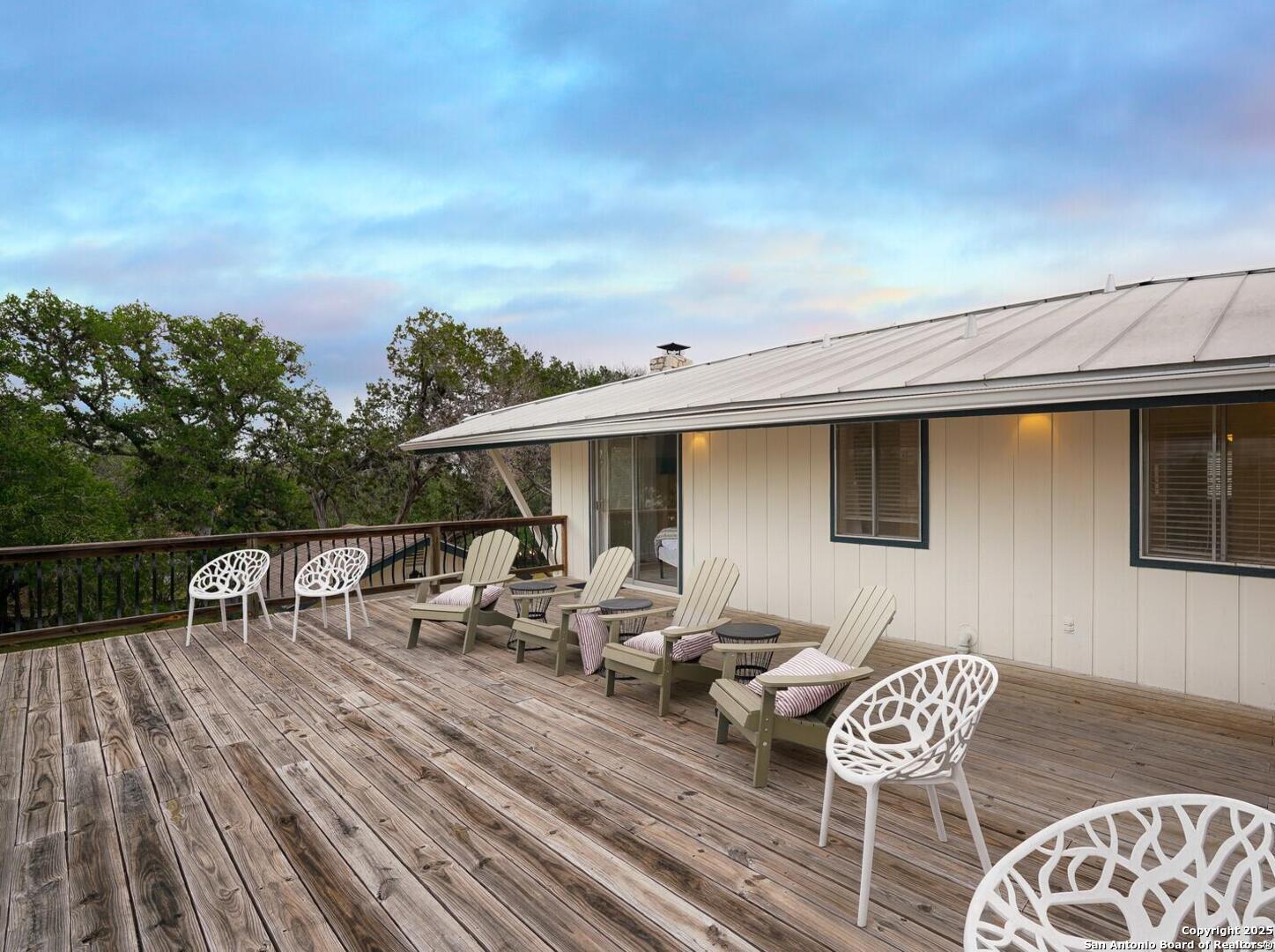 550 County Road 262 Mico, TX 78056 - Photo 34 of 58 a roof deck with table and chairs with wooden floor