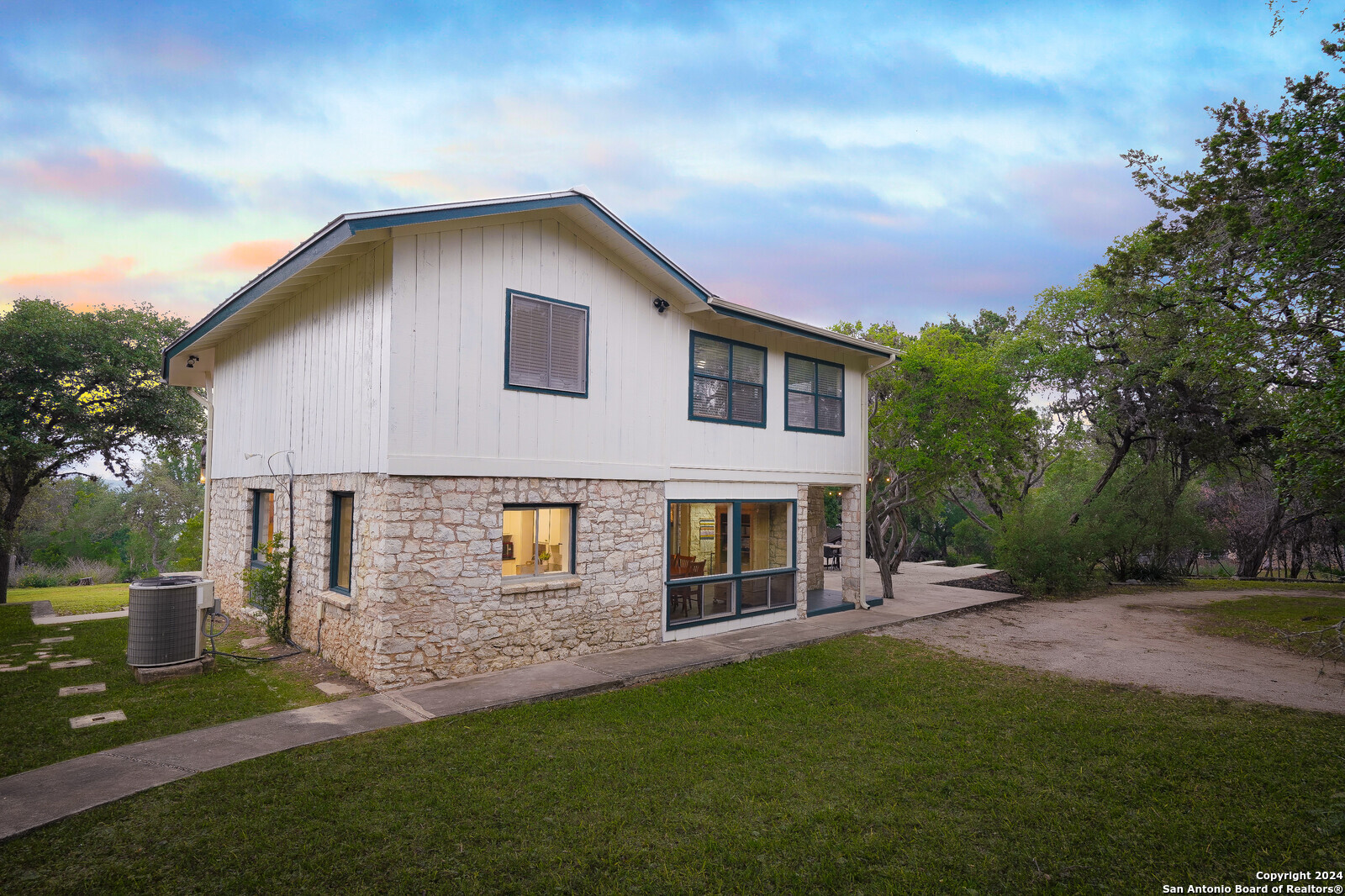 550 County Road 262 Mico, TX 78056 - Photo 36 of 58 a front view of a house with a garden