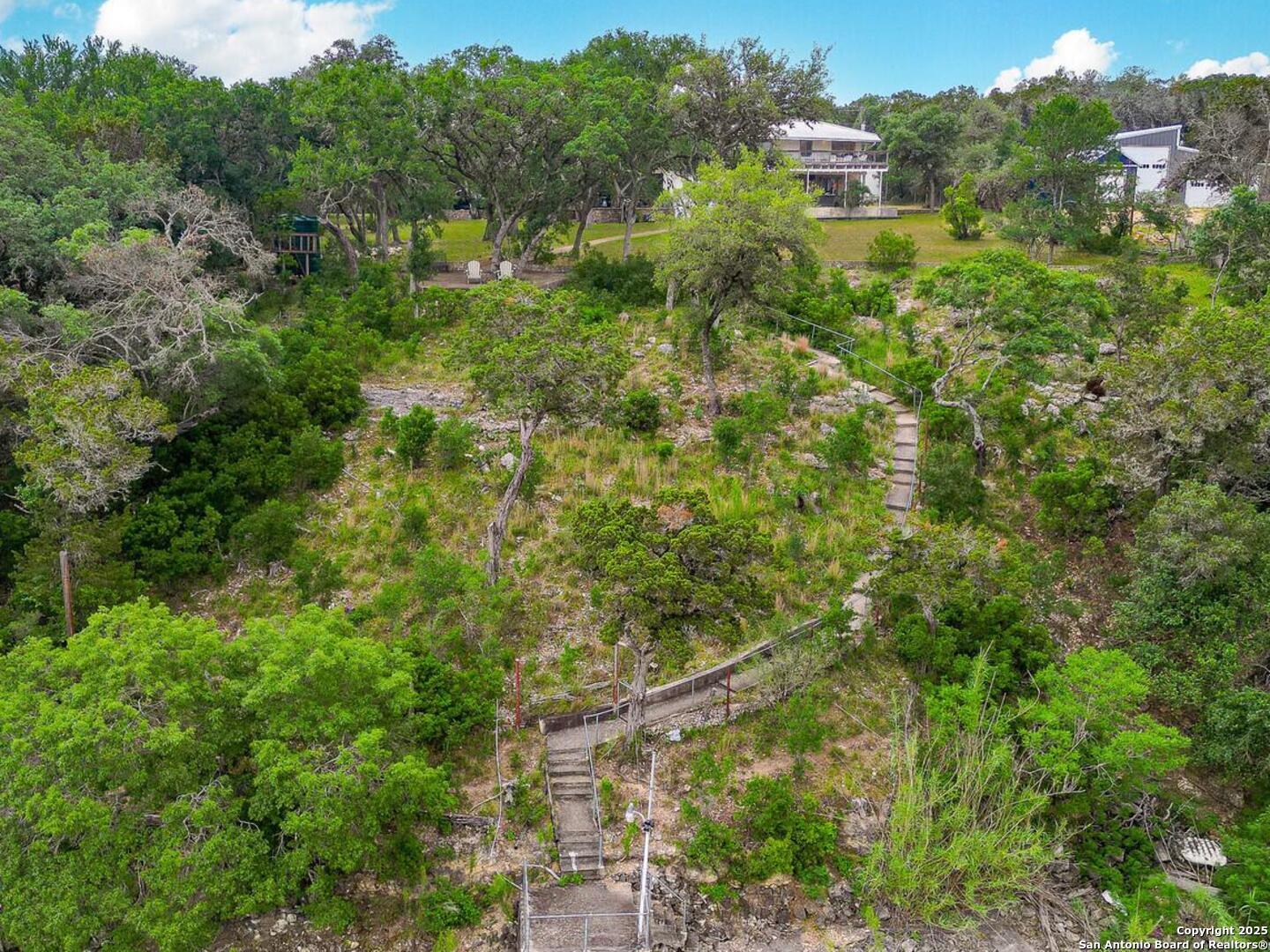 550 County Road 262 Mico, TX 78056 - Photo 46 of 58 an aerial view of residential house with outdoor space and trees all around