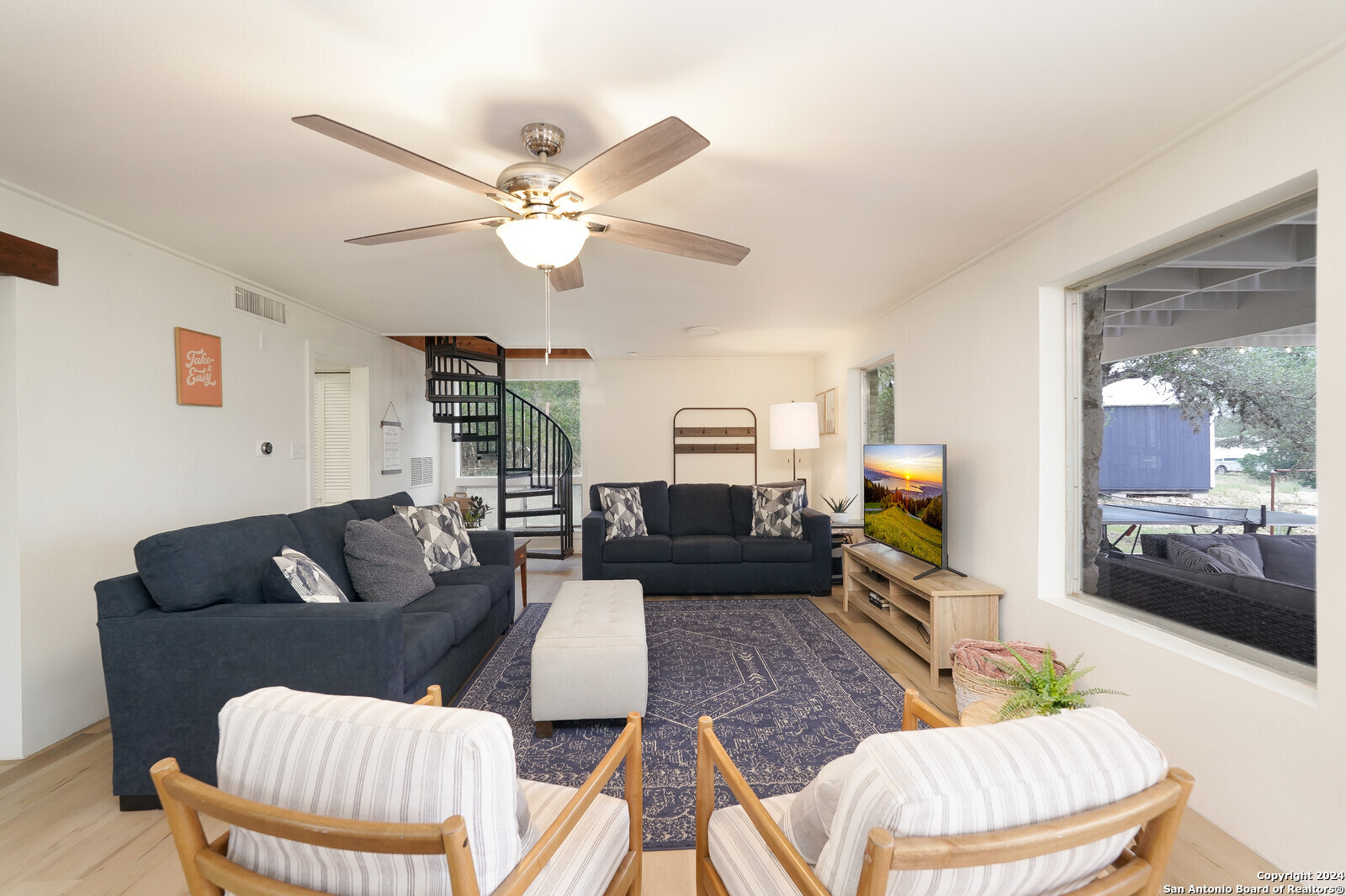 550 County Road 262 Mico, TX 78056 - Photo 10 of 58 a living room with furniture a ceiling fan and a rug