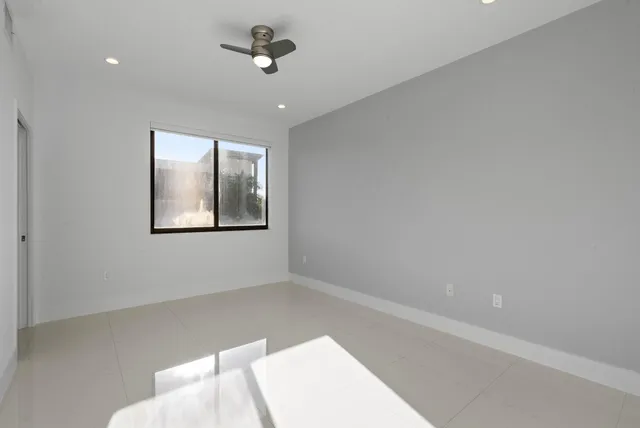 a bathroom with a sink double vanity granite tub shower and a mirror