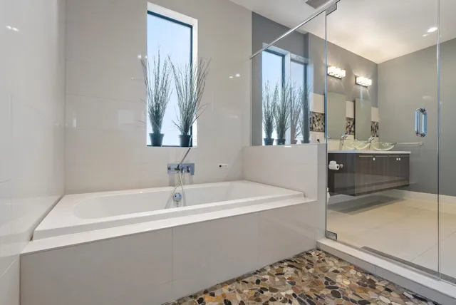 a view of a lake with a yard and large trees